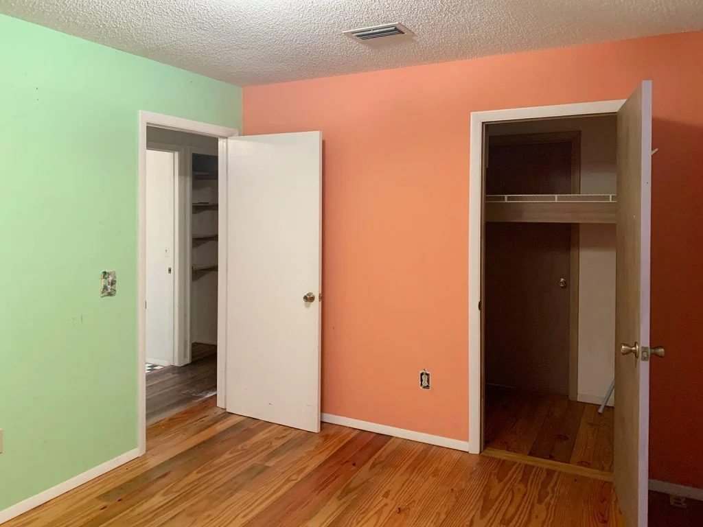 Before photo of girls bedroom with neon walls and closet door