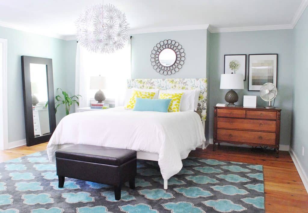 Blue bedroom with patterned Hands-on upholstered floral headboard