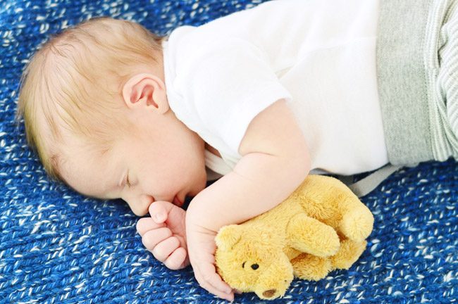 Hands-on Newborn Photo Shoot With Infant Boy On Blue Blanket With Bear