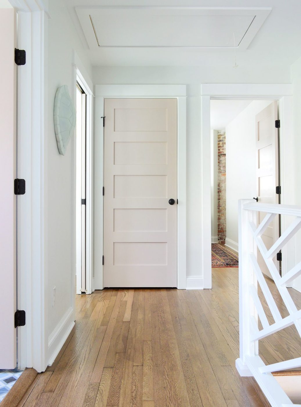 After Photo With Moved Doors And Brought in Linen Closet And Decorative Railing | White Truffle Painted Doors