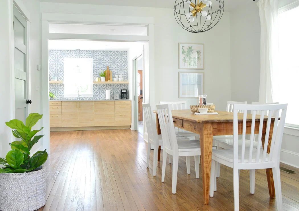 Duplex Dining Room With Blue And Wood Kitchen In Background