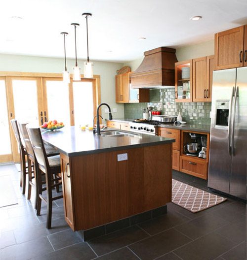 A Kitchen Alongside Wood Cabinets & Sage Green Tile