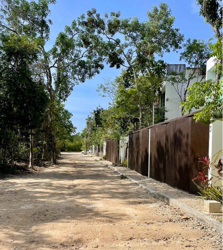 Unpaved Street With Gated Homes In La Veleta Tulum Mexico
