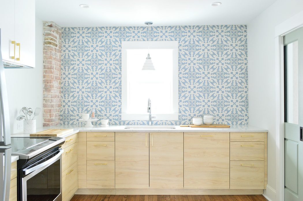 Wood Ikea Kitchen With Exposed Brick Chimney and Blue White Patterned Tile