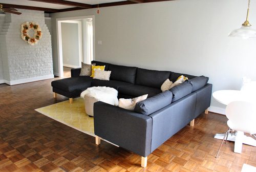 dark gray Karlstad ikea sectional sofa lately assembled in gray living room with fireplace
