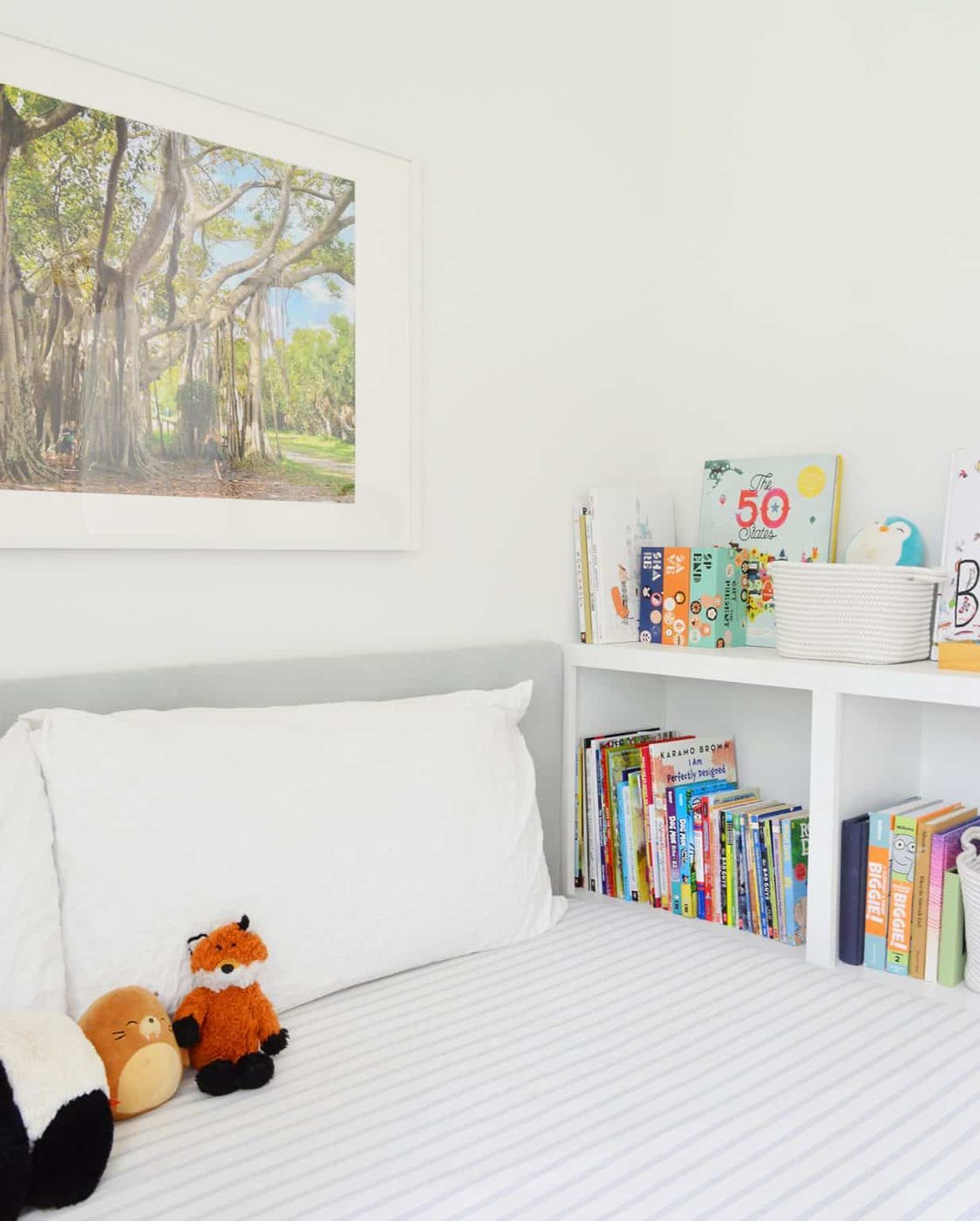 Boys bedroom with Hands-on fabric upholstered headboard and custom built-in bookcase footboard