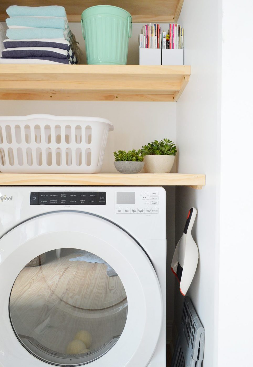 Profile view of laundry closet with Hands-on wood floating shelves
