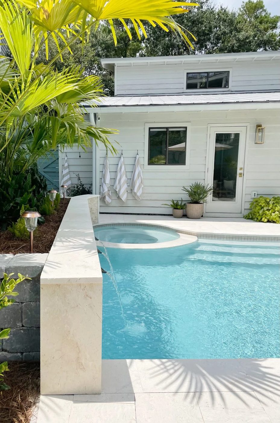 Backyard pool with round hot tub in small home backyard