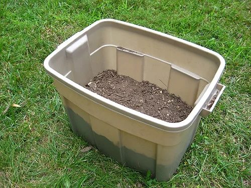 layer of dirt brought in to homemade compost bin