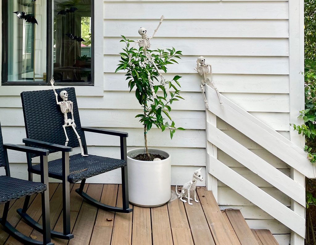 Skeletons On Front Porch Posed In Distinct Positions