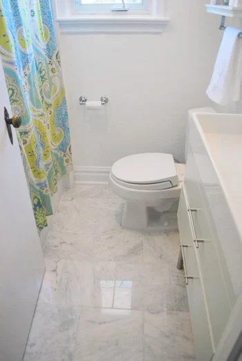A Small Bathroom Update Alongside Teal Glass Tile