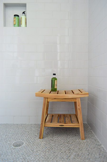 Wood Stool In Walk In Shower With Gray Penny Tile Floor