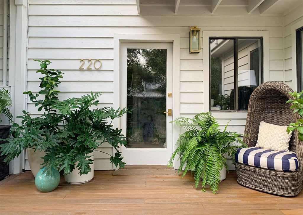 Front Porch With Glass Door And Plenty Of Plants