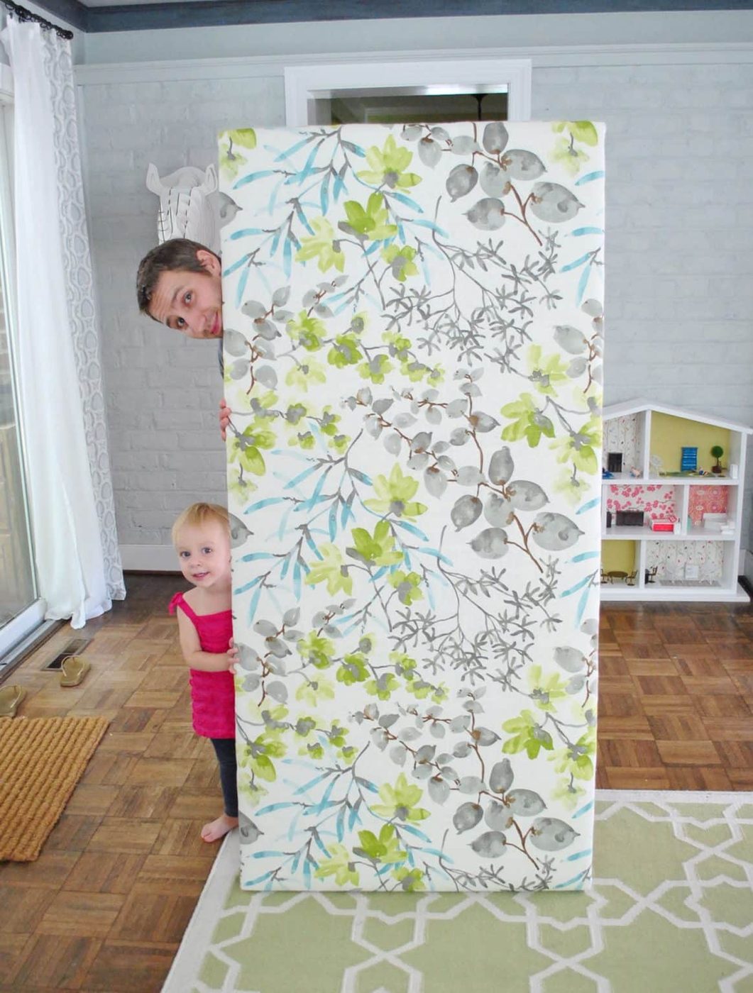 John standing with wrapped up Hands-on fabric headboard