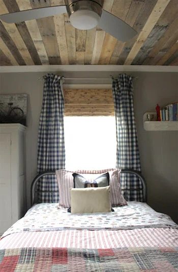A Boy’s Bedroom Alongside A Wood Plank Ceiling & Checkered Curtains