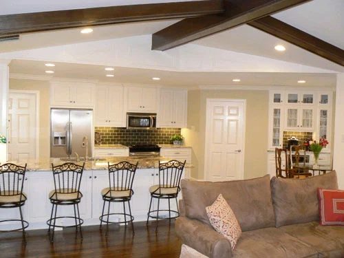 A Living Room Alongside Painted Paneling And Wood Beams