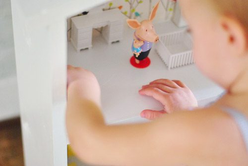 Overhead View Of Little Girl Playing With Homemade Hands-on Wood Modern Dollhouse
