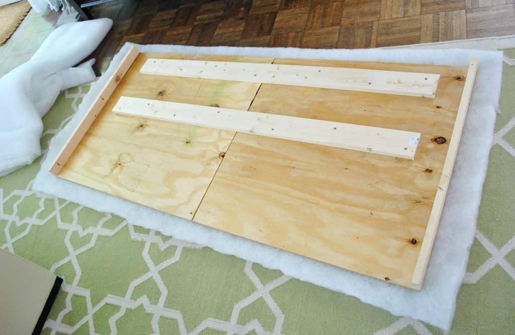 Layer of batting placed under Hands-on headboard wood frame