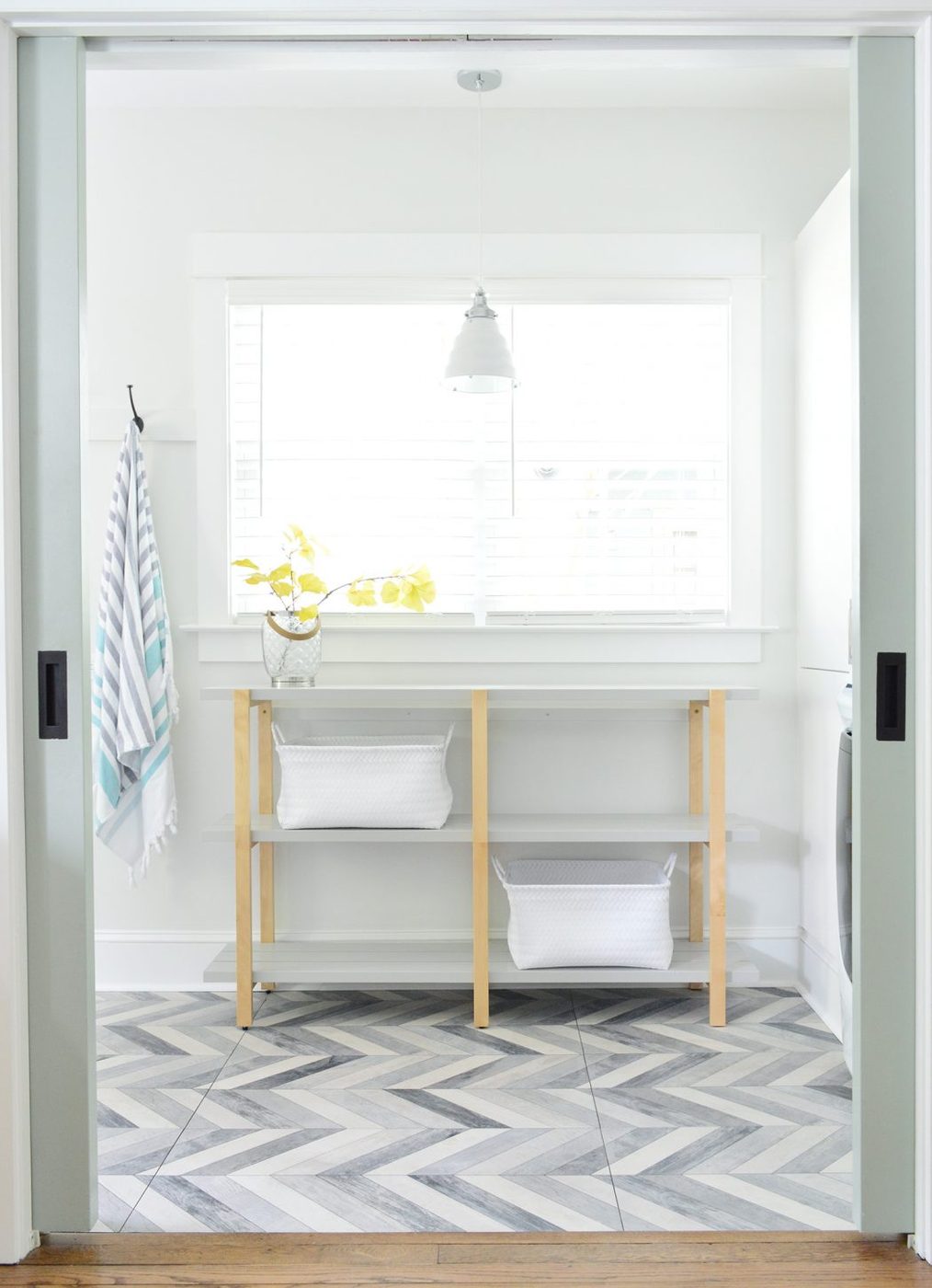 Open Shelf Through Pocket Doors In Duplex Mudroom Laundry