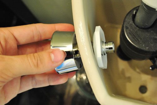Attaching dual flush button to toilet tank