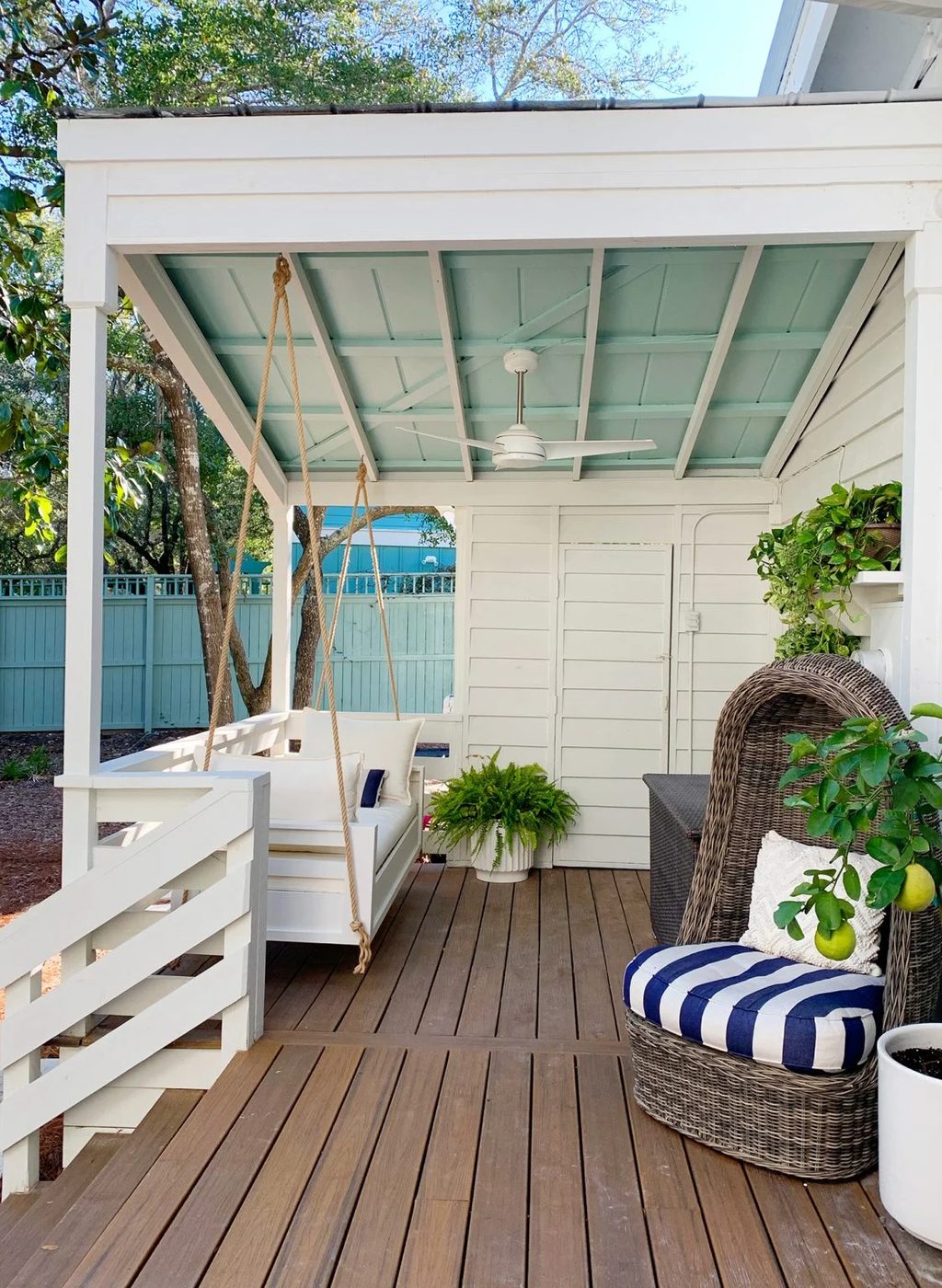 Wrapped up White Hanging Daybed Under Covered Front Porch