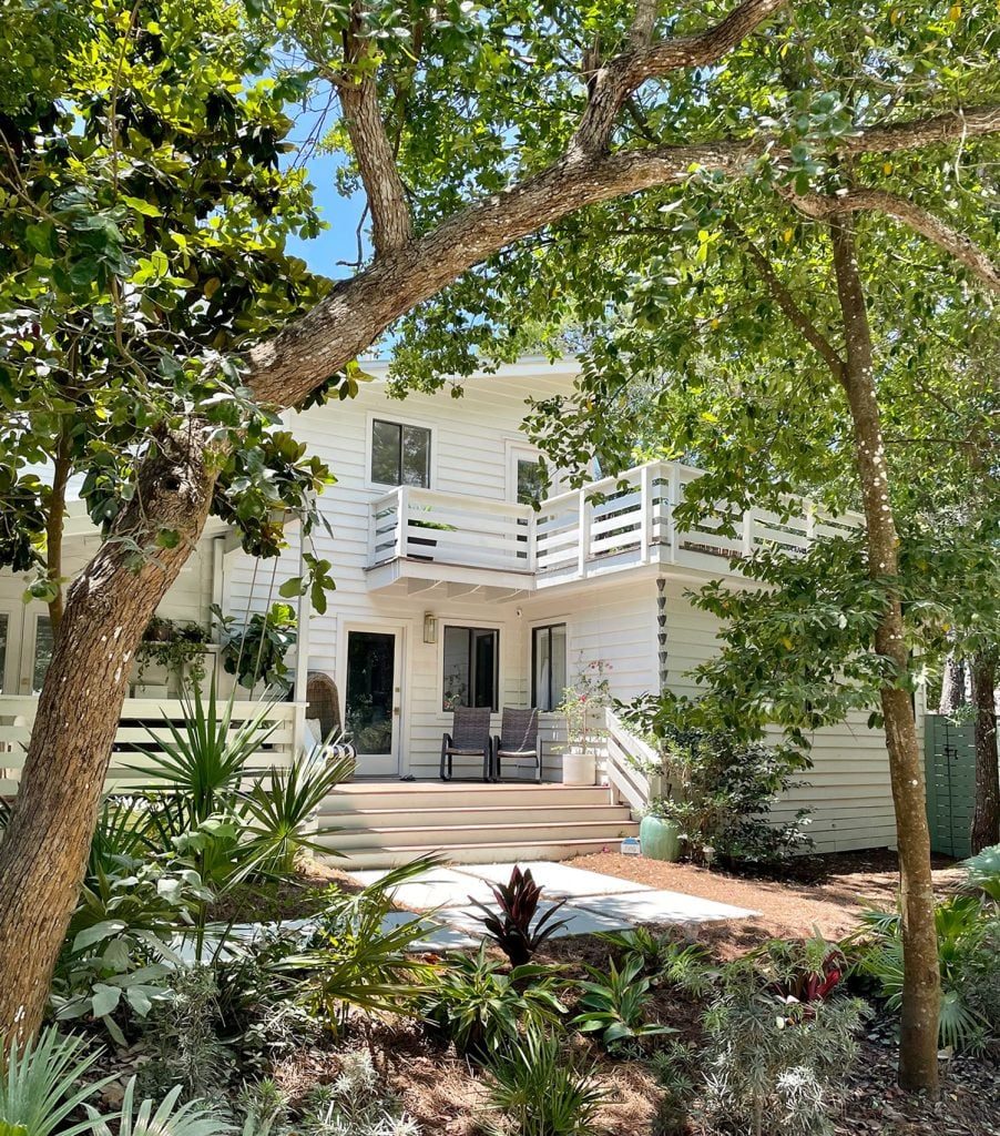 Front Of White Modern House With Plenty of Greenery Angle