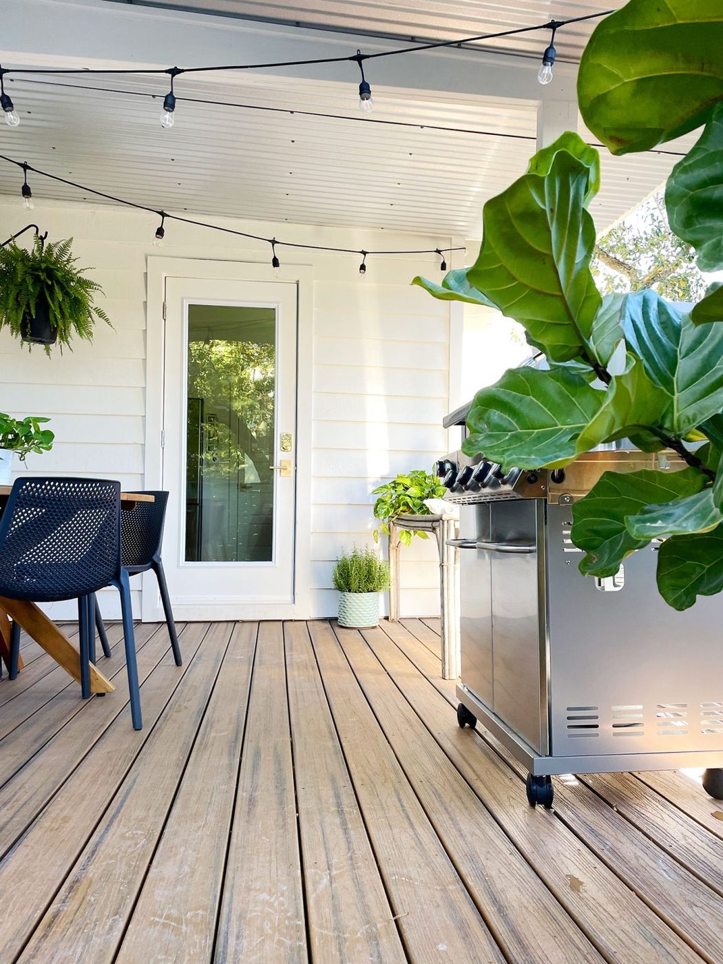 Empty space on porch for straightforward passage between table and grill to new door in house