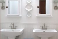 Luxe All-White Bathroom with Stylish Pedestal Sinks