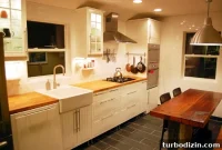 White Kitchen With Butcher Block Countertops and Apron Sink