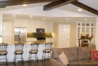 Painted Paneled Living Room with Exposed Wood Beams