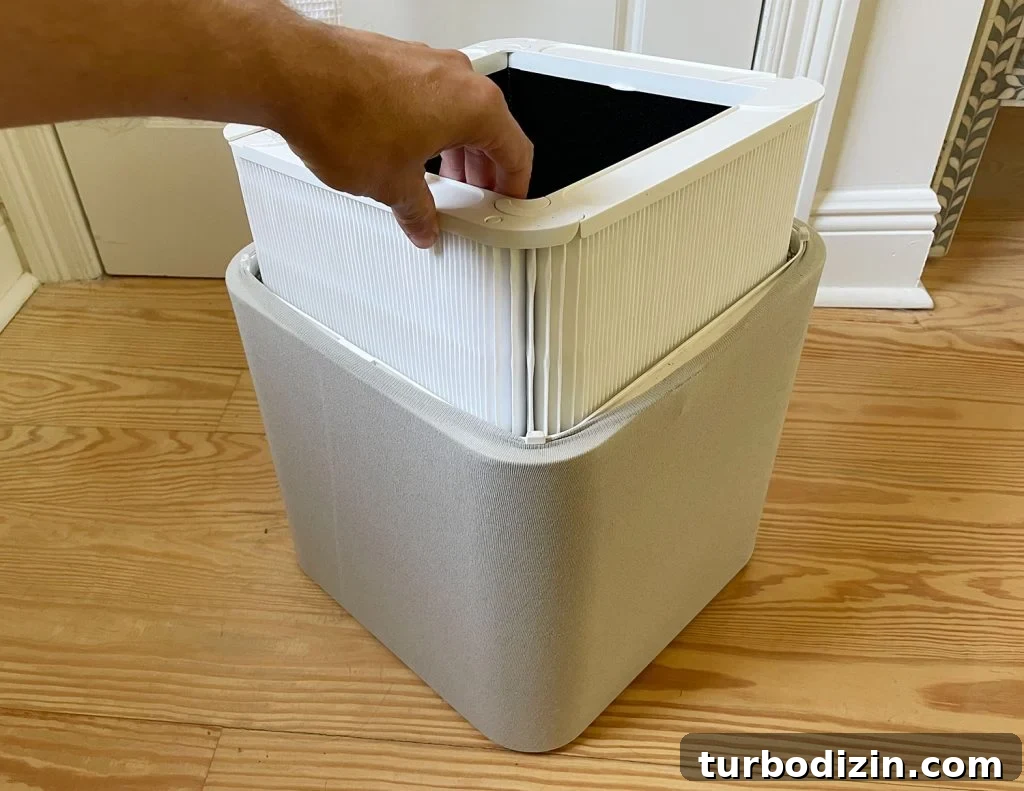 Top Home Air Purifiers for Cleaner Indoor Air 6 Inserting New Clean Air Filter Into Blueair Blue 211 Air Purifier