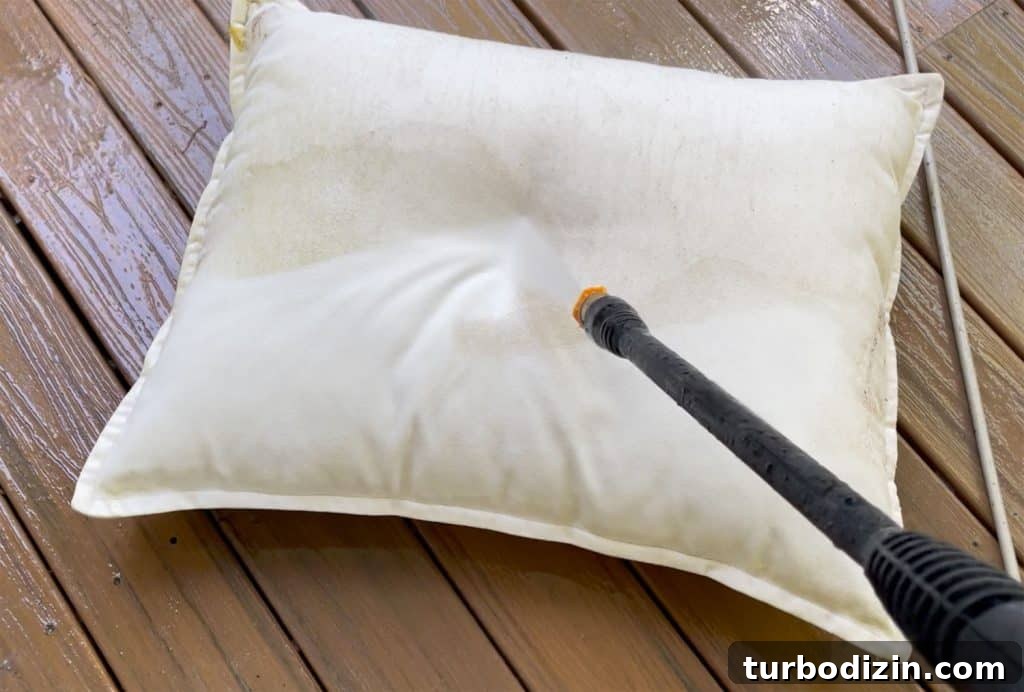 Spraying Outdoor Pillow With Electric Pressure Washer