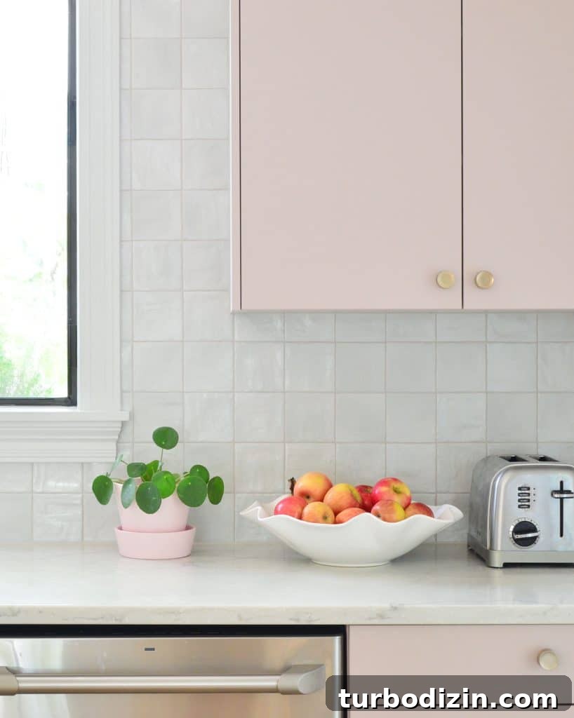 Ikea Kitchen Makeover: Smart Renovation Ideas for Small Spaces 2 Square Tile Backsplash With Mauve Pink Painted Cabinets And Fruit Bowl