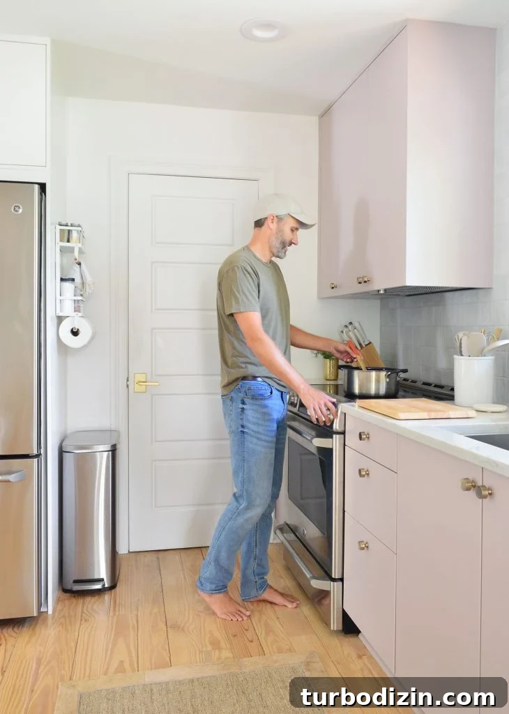Ikea Kitchen Makeover: Smart Renovation Ideas for Small Spaces 15 John Standing At Stove Cooking In Mauve Painted Ikea Kitchen