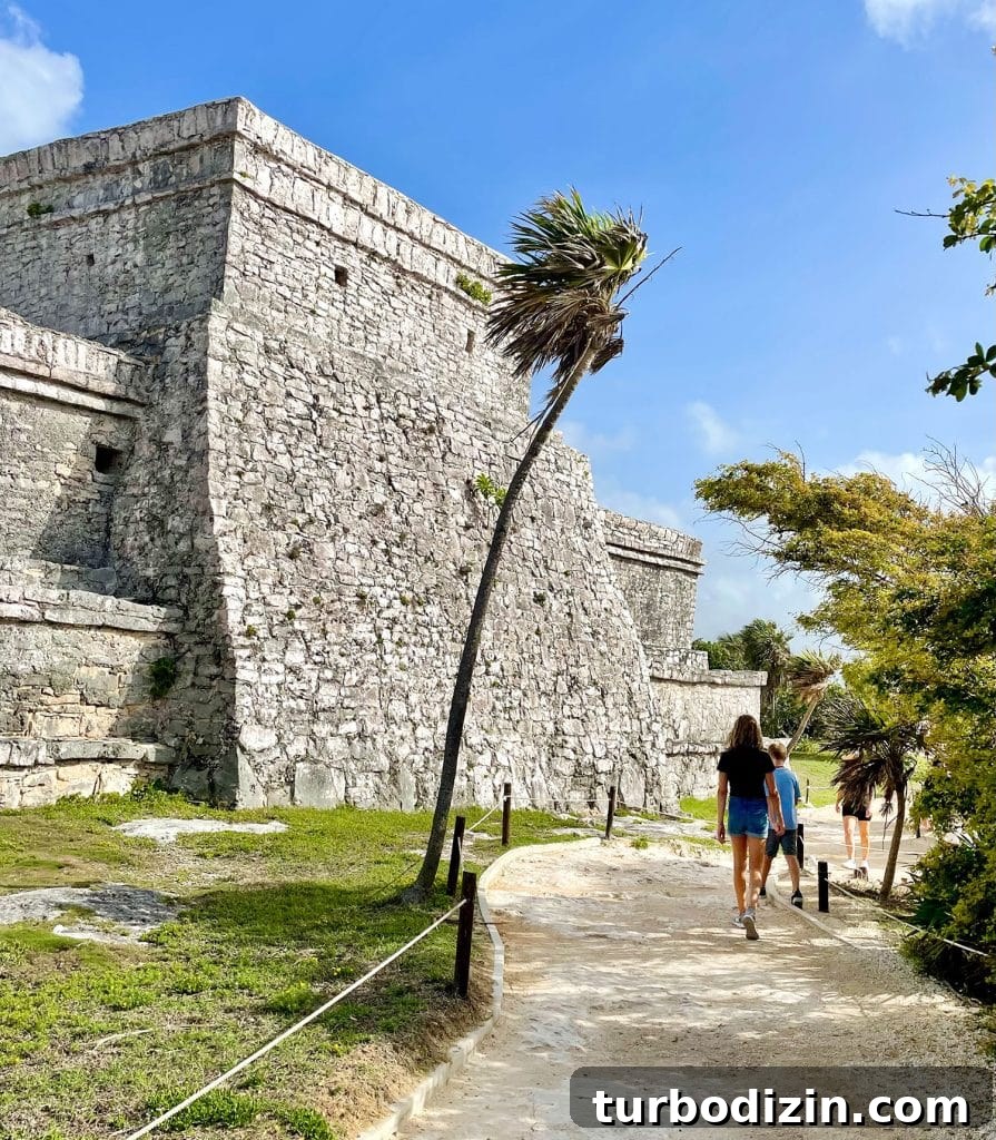 Traveling to Mexico with Kids and a Dog: Family Guide 16 Kids Walking In Front of Castillo At Tulum Ruins Mexico