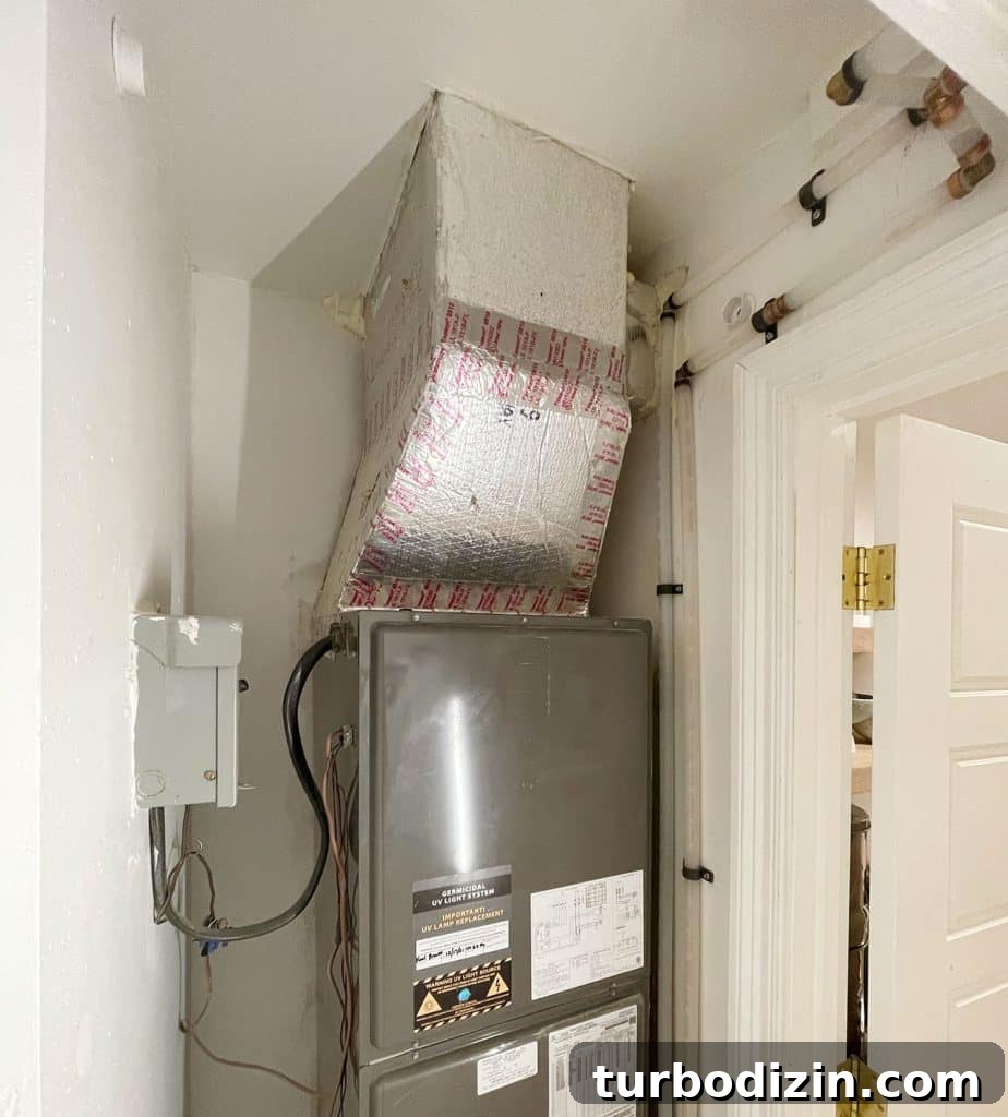View of inside of closet with clean plumbing pipes running behind door molding