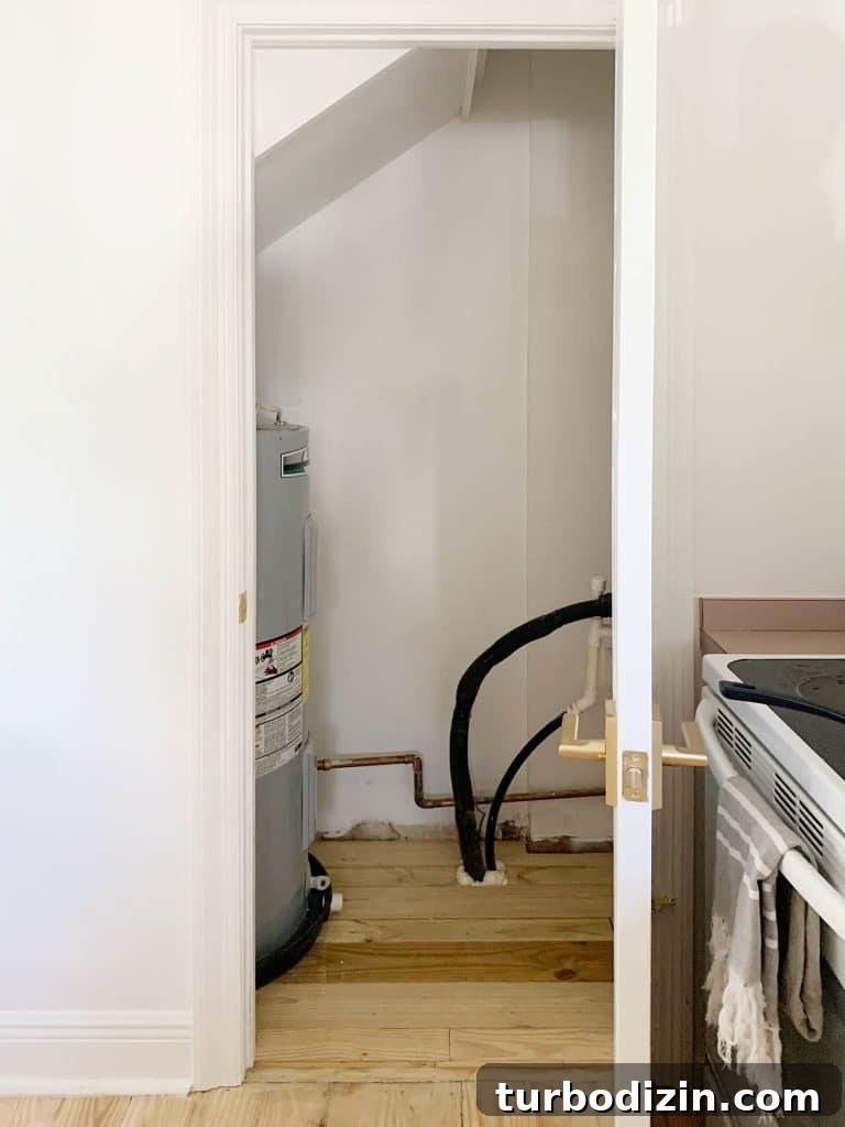 Before Photo Of Utility Closet With Large Water Heater Tank