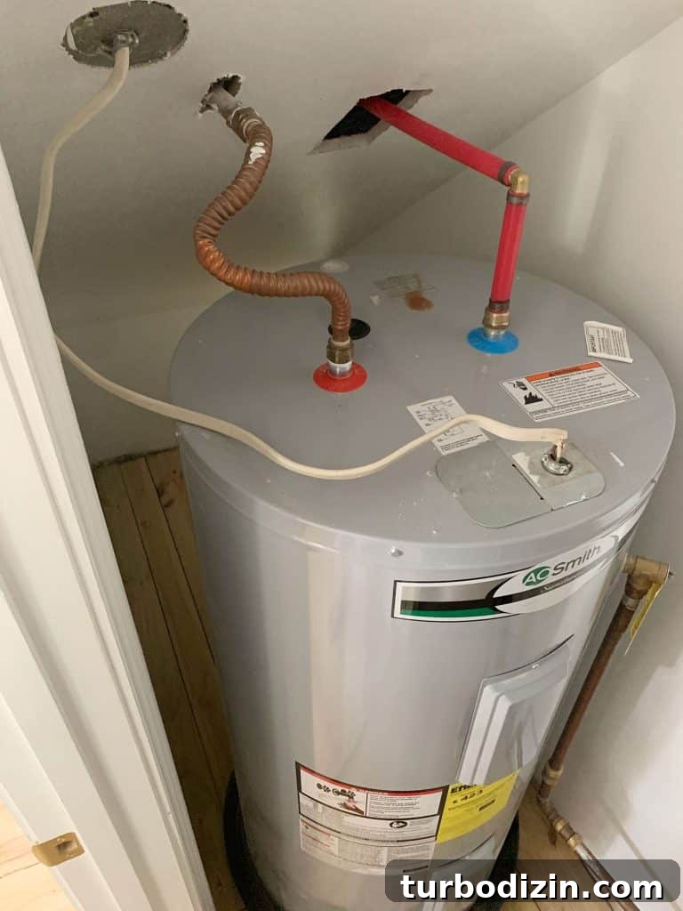 Before Photo Of Large Electric Water Heater Tank In Utility Closet