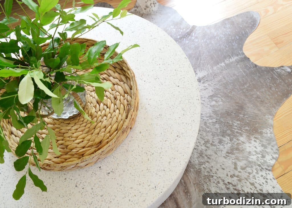 Overhead View Of CB2 Terrazzo Outdoor Coffee Table On Metallic Cowhide Rug