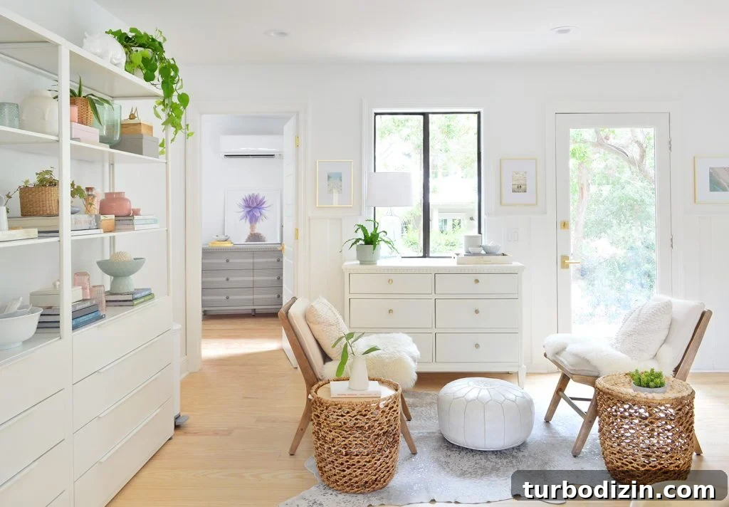Beachy sitting room with white shelves and large dressers with floating chairs and baskets