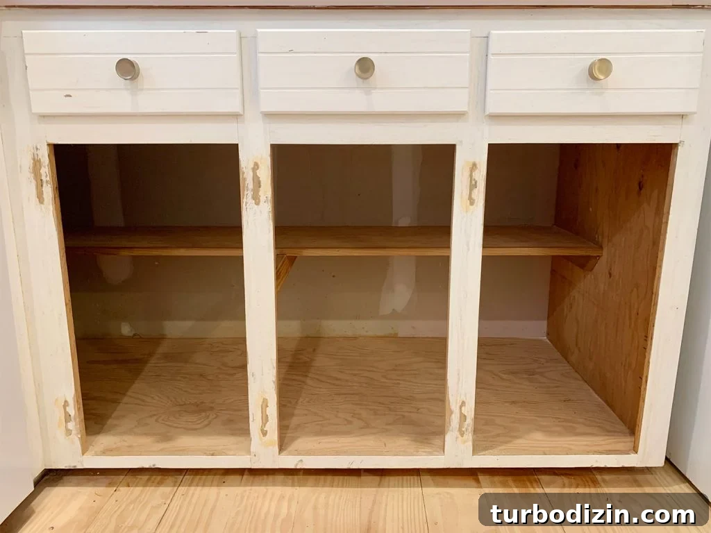 Three lower cabinet frames sanded and holes filled with wood filler