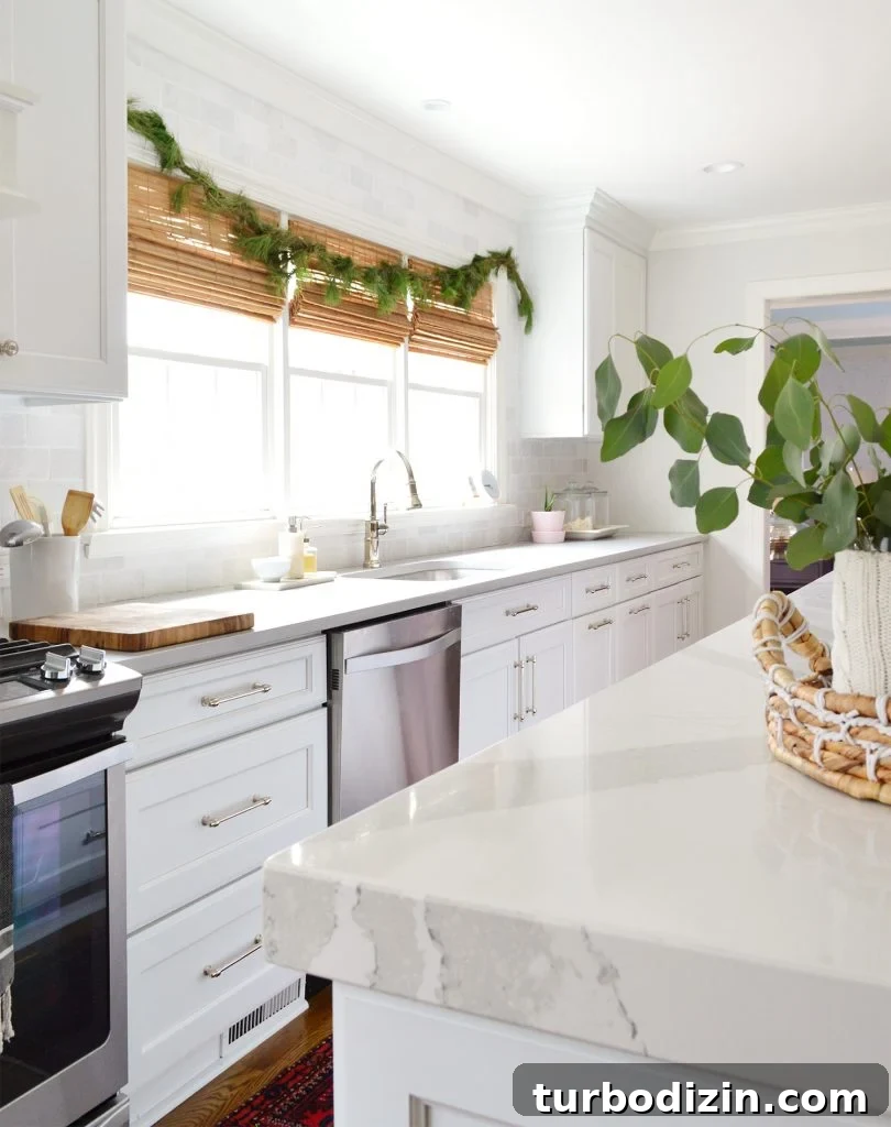 White Kitchen With Holiday Fir Garland Over Sink Windows