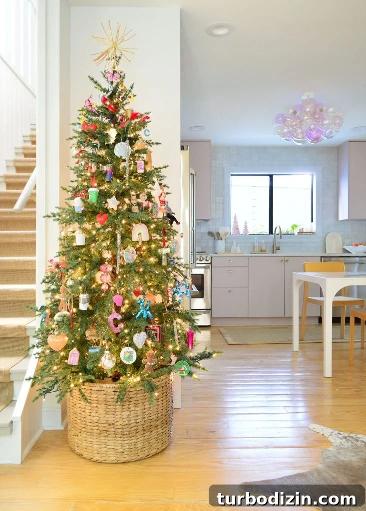 Slim Artificial Christmas Tree In Kitchen With Pink Cabinets