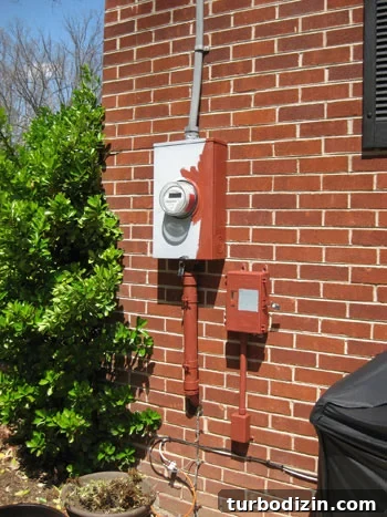 img_8698 Half painted gray electrical utility meter box on back of brick ranch home
