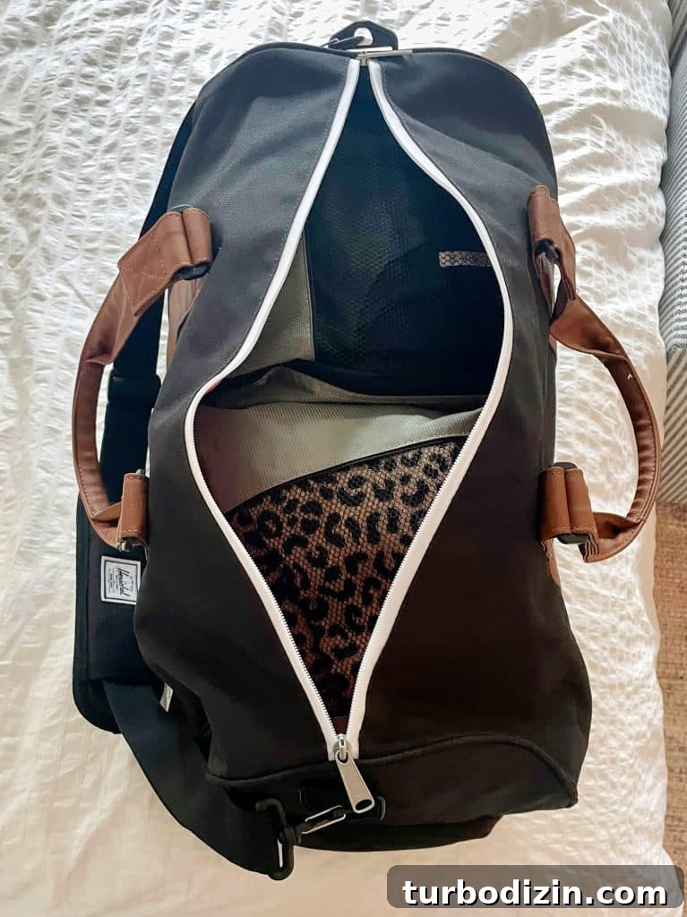 Overnight duffel bag packed with packing cubes on bed