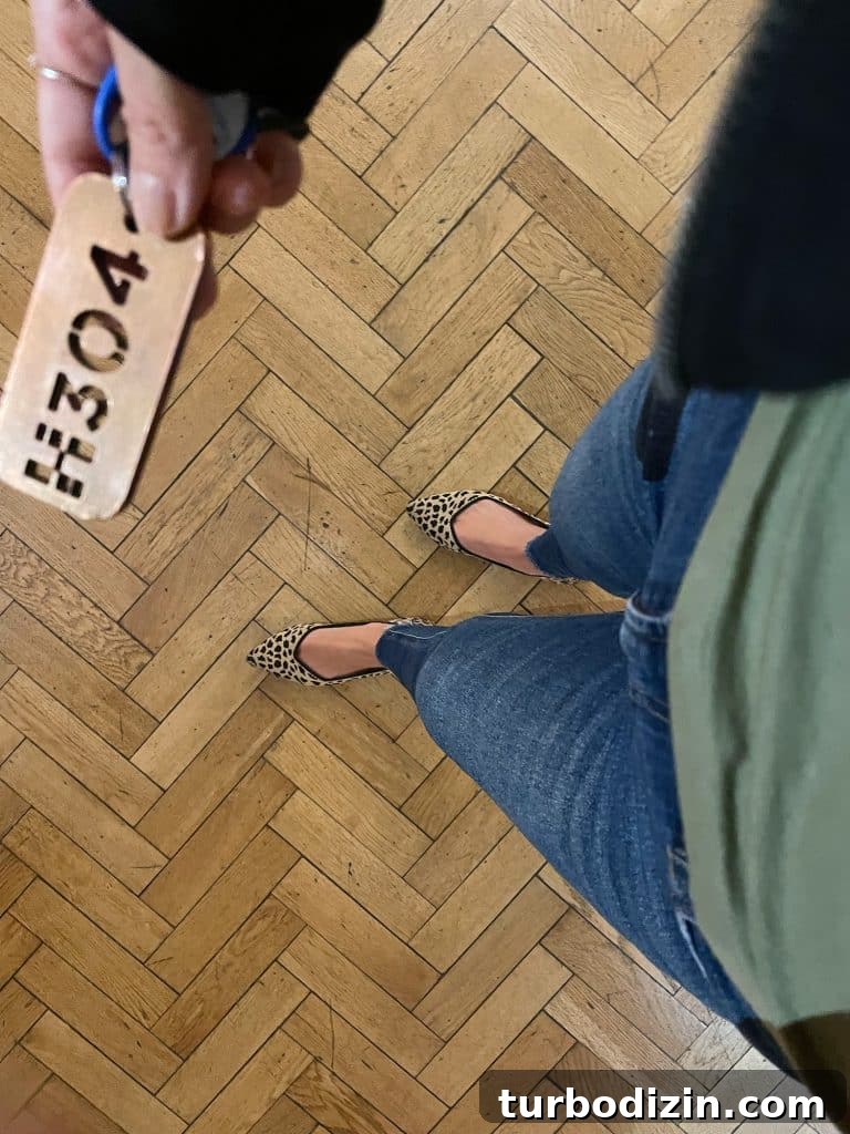 Shot from above at jeans and leopard flats on herringbone wood floor