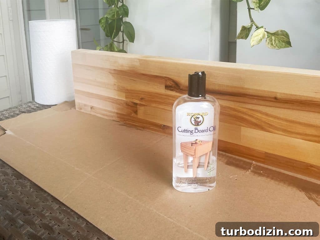 Transform IKEA Besta into Seamless Built-In Storage 11 Butcher block counter being coated with cutting board oil sealant