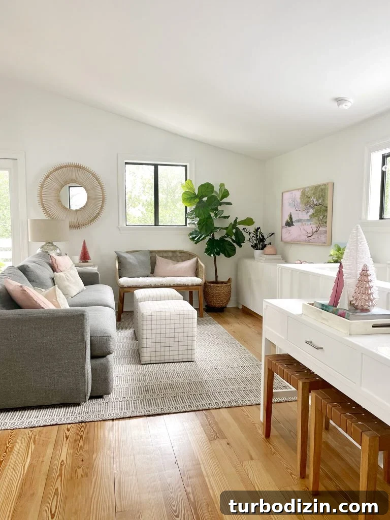 Angled view of living room with new sheepskin loveseat and decorative Christmas trees on tabletop