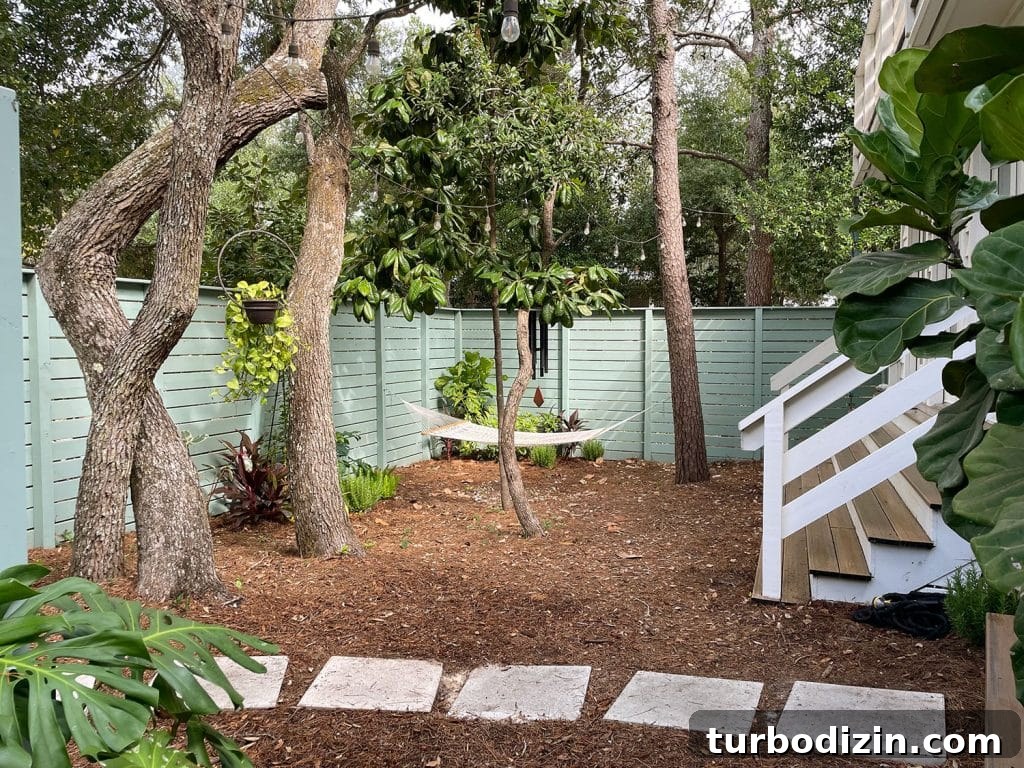 Full View Of Side Yard With Hammock Hanging Among Trees