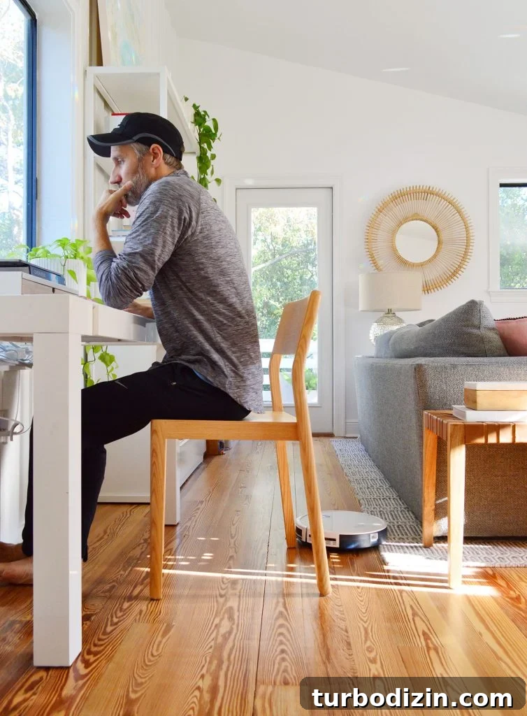 Are Robot Vacuums Worth the Investment? 16 Eufy RoboVac 11S Robot Vacuum Working Around Johns Desk Chair